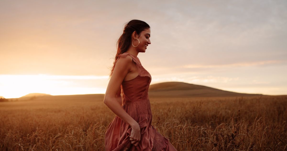 Woman in dress walking at sunset ftare a ketamine treatment in Wyckoff, NJ
